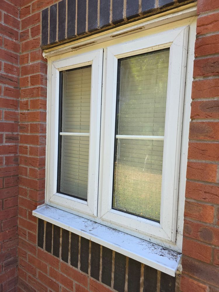 Window with grubby, filmed-over glass before cleaning