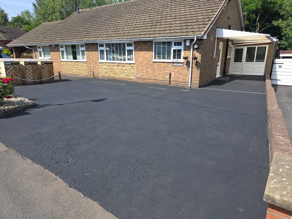 The same driveway restored to a deep jet-black sealed finish