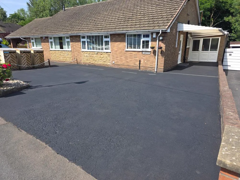 The same driveway restored to a deep jet-black sealed finish