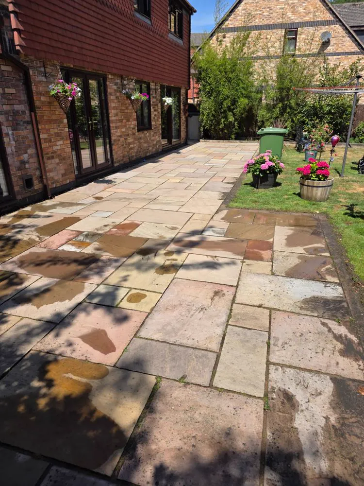 The same patio pressure washed back to fresh, clean stone