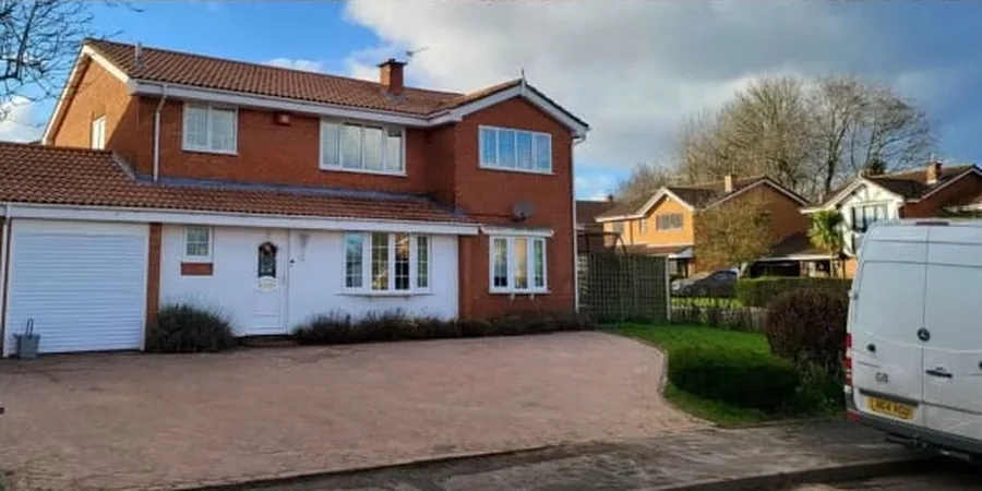 The same Telford house after its roof clean, terracotta tiles clear of moss