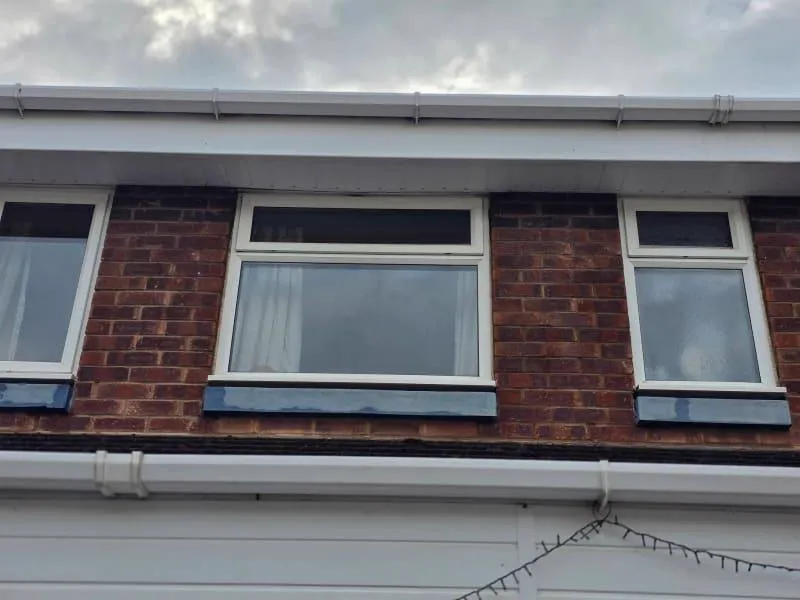 The same roofline restored: bright white soffits, fascias and gutters
