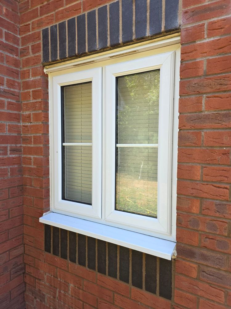 The same window with clear, streak-free glass after a hot pure water clean