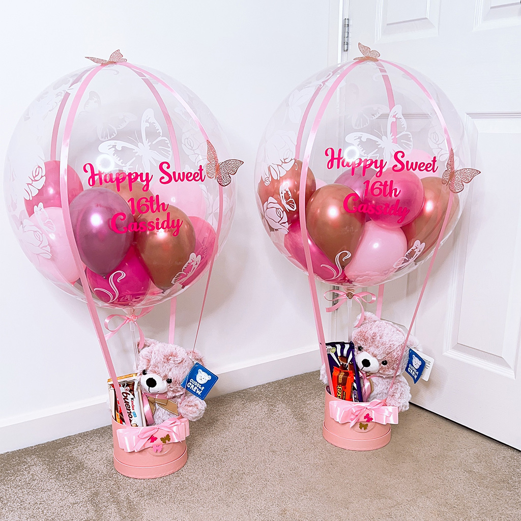 Pink hot air balloon gift baskets personalised for a sweet sixteenth, with teddy bears and chocolates