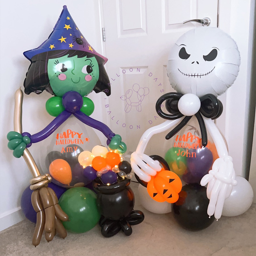 Handmade Halloween balloon sculptures of a witch and a skeleton character