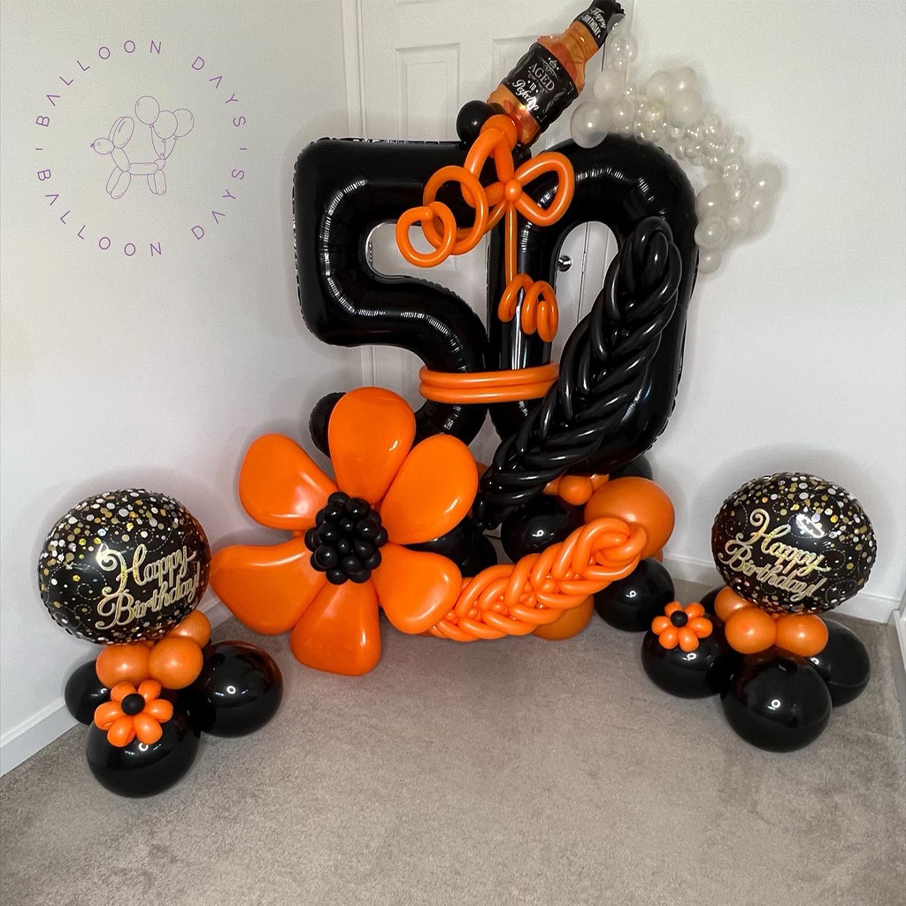 Black and orange fiftieth birthday balloon sculpture display