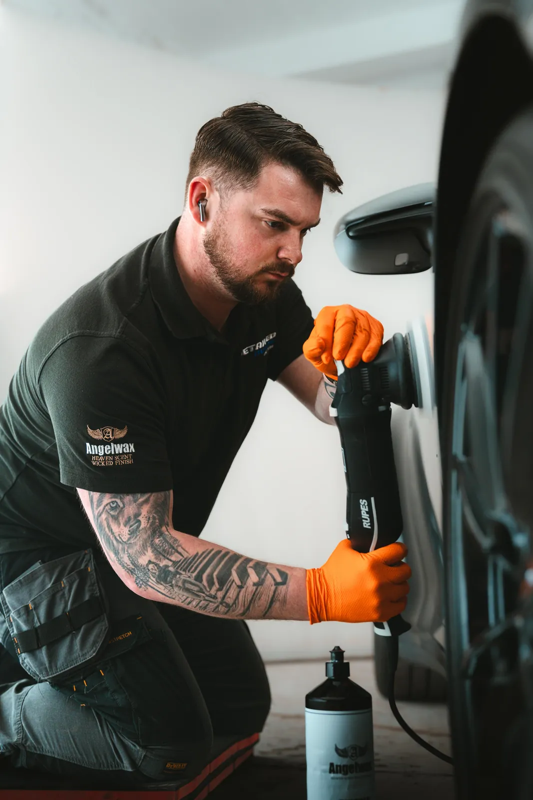 Detailed Autos specialist machine-polishing a car panel with a RUPES polisher
