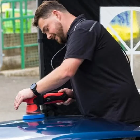Kieron of Detailed Autos machine-polishing the roof of a car