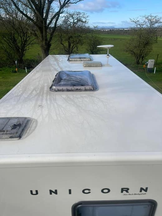 The same Bailey Unicorn roof after cleaning, the surface bright white with the rooflights and aerial clear.