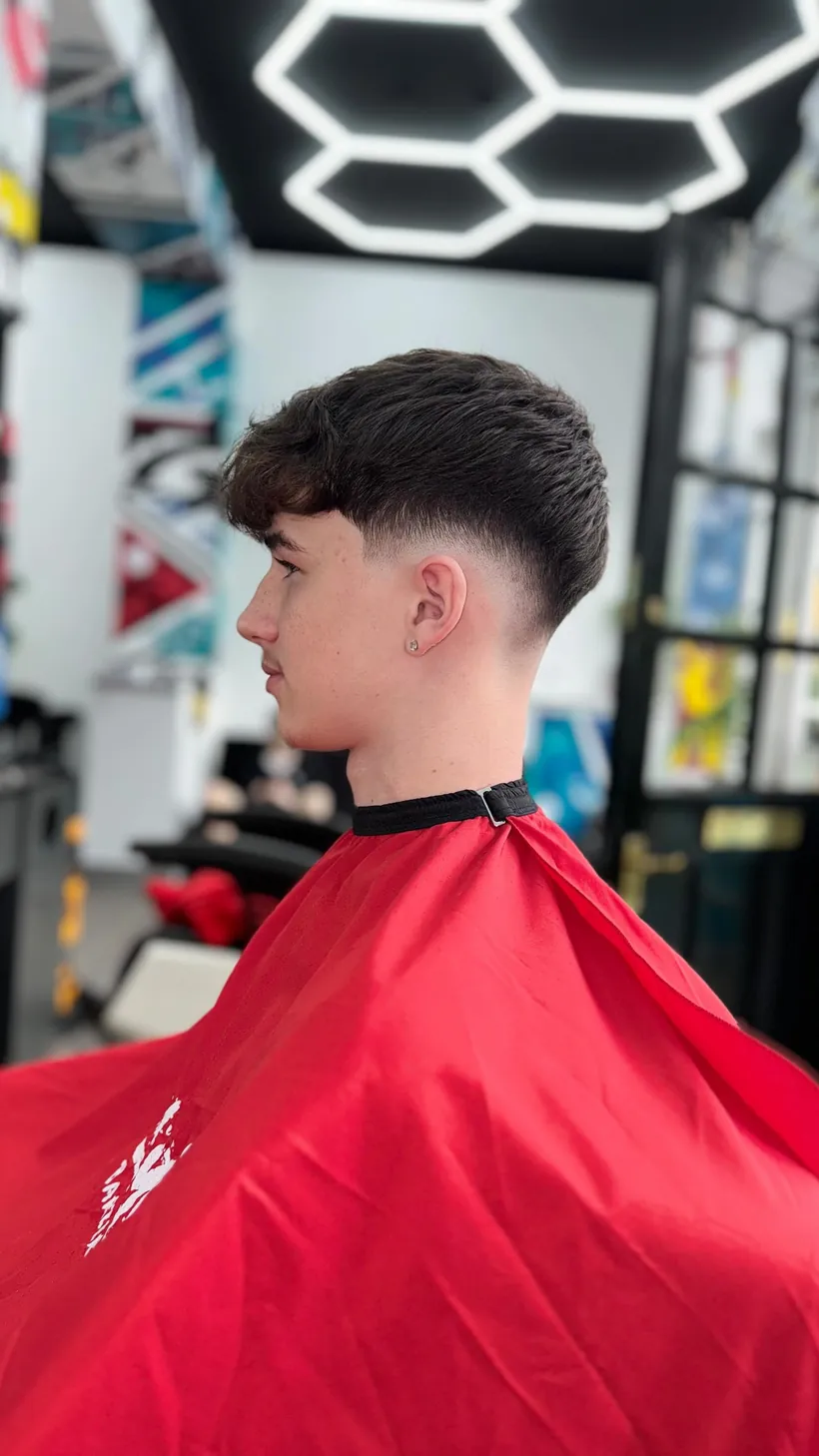 Side profile of a fresh fade and textured fringe