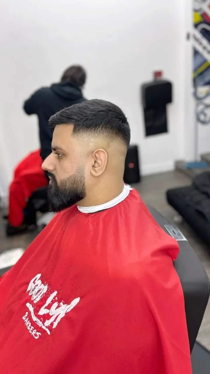 Fade and full beard in a red GoodLyf cape