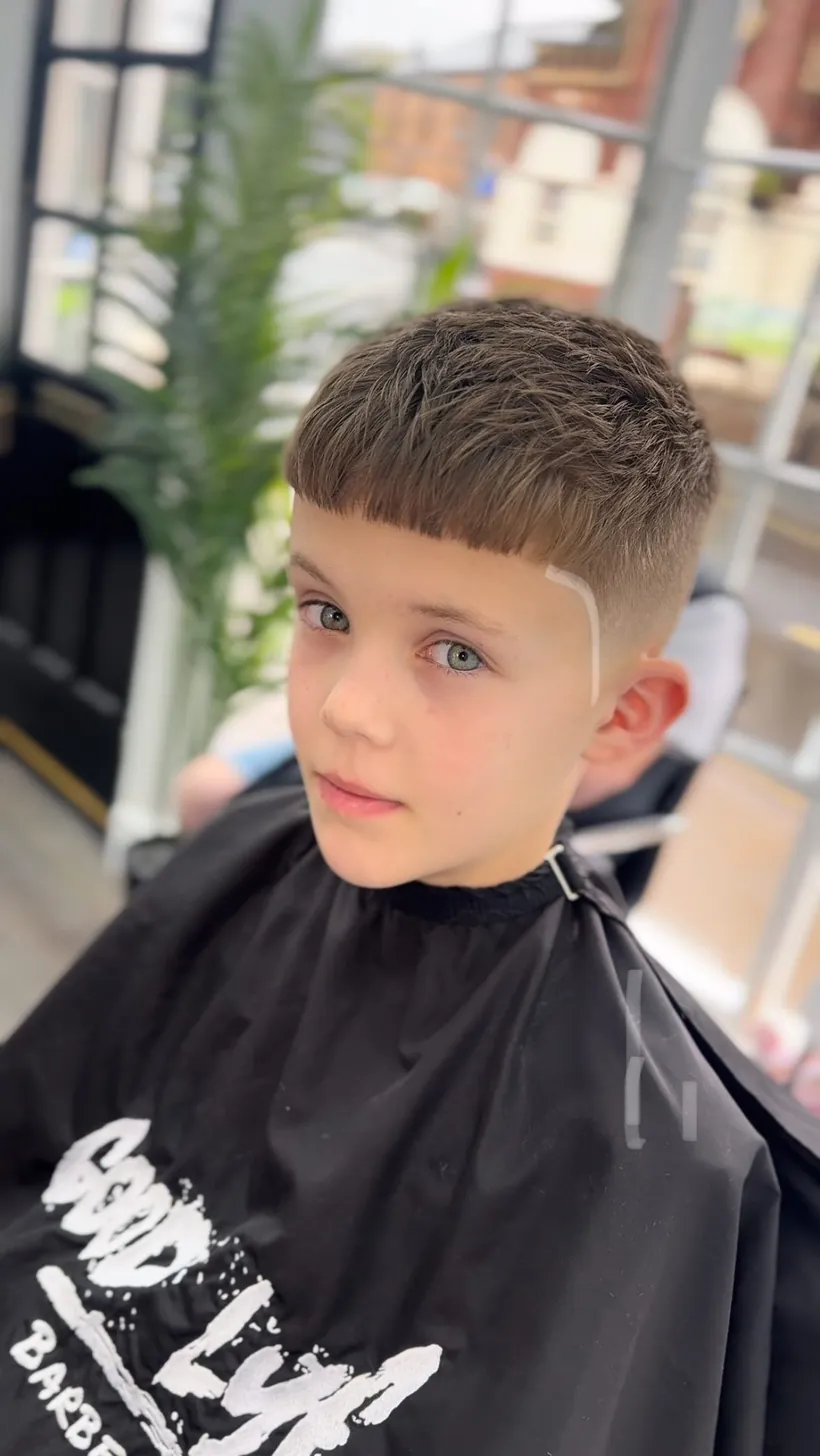 A young client's fresh cut in a GoodLyf cape