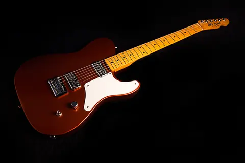 The copper metallic J. Davey Cabronita Telecaster, full body and maple neck, photographed on black