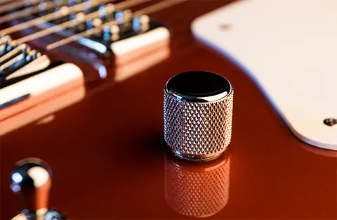 A single chrome control knob on the copper Cabronita, shot close against the metallic finish