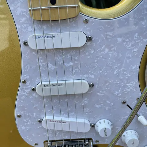 Close view of the three Lace Sensor pickups on the gold Stratocaster pearl pickguard