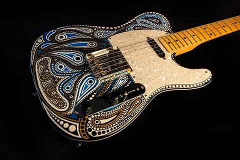 A J. Davey Telecaster hand painted with blue, gold and white paisley and dot artwork, with a pearl pickguard and gold hardware