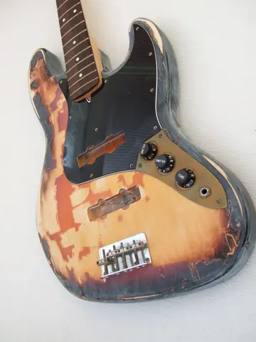 The relic'd J. Davey Seasoned Series Jazz Bass from a second angle, showing the worn sunburst finish and aged hardware