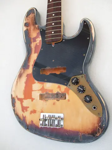 A heavily relic’d J. Davey Seasoned Series sunburst Jazz Bass, worn back to bare wood, with a rosewood fingerboard