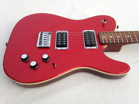 The matte red J. Davey Showroom Series guitar from above, showing the three pickups and control layout