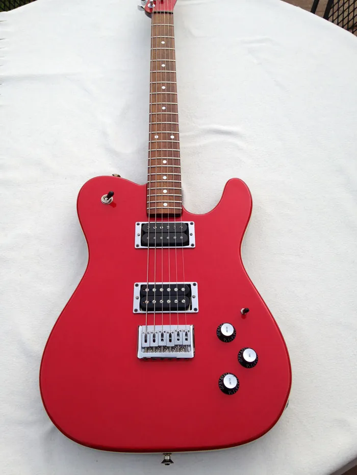 A matte red J. Davey Showroom Series Telecaster shaped guitar with two humbuckers, a single coil and a rosewood fingerboard