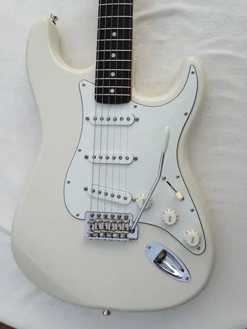 The white J. Davey Signature Series Stratocaster from above, showing the pickguard, controls and tremolo arm