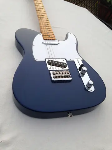 A dark blue J. Davey Standard Series Telecaster with a white pickguard, maple neck and chrome hardware