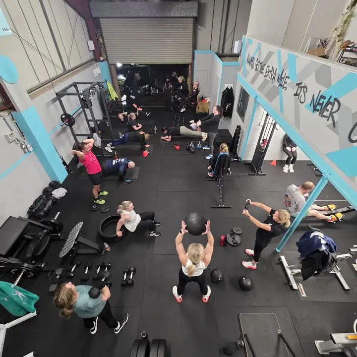 A busy evening class at Unit 49 seen from above, people training at every station.
