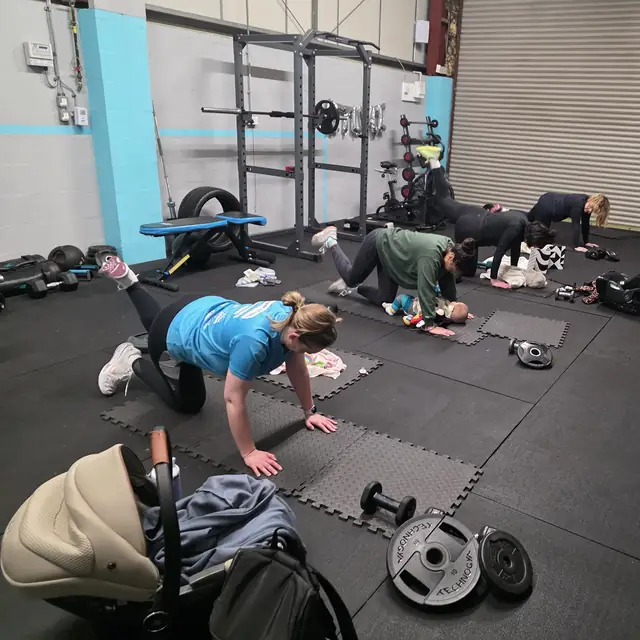 Mums training on mats in the Let Luce studio, a pram beside them.