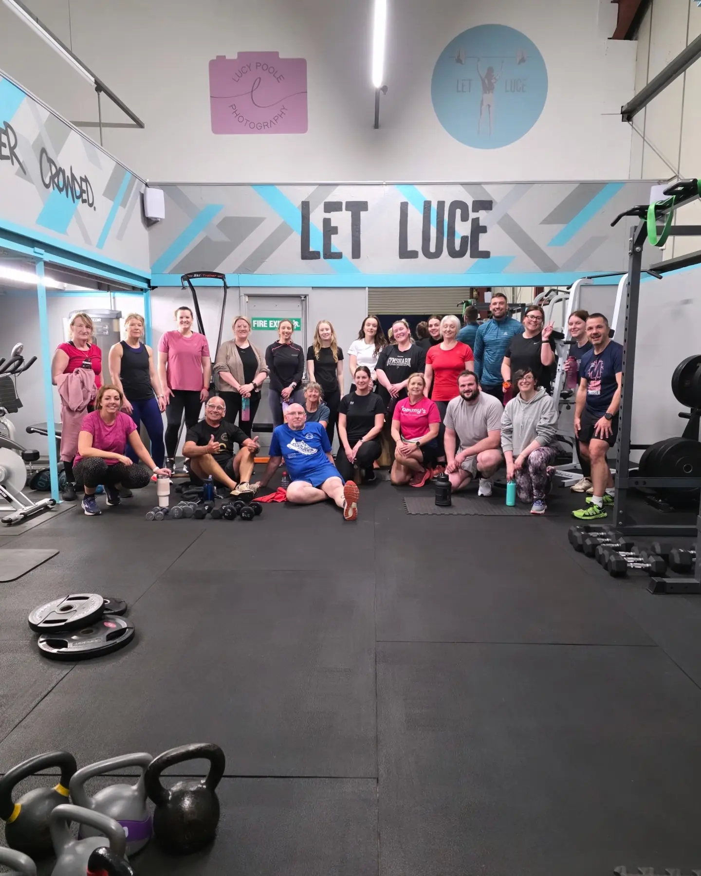 A big Let Luce group smiling together inside Unit 49.