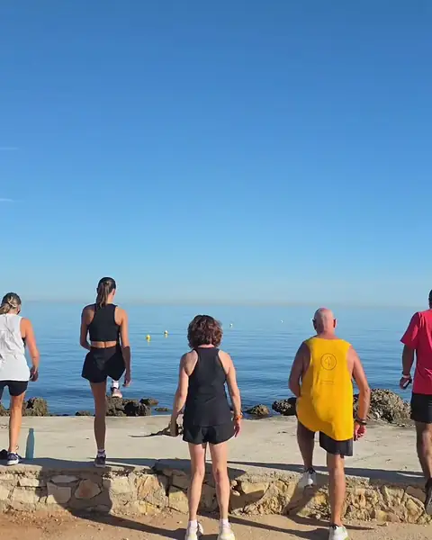 A group doing step-ups on the seafront.