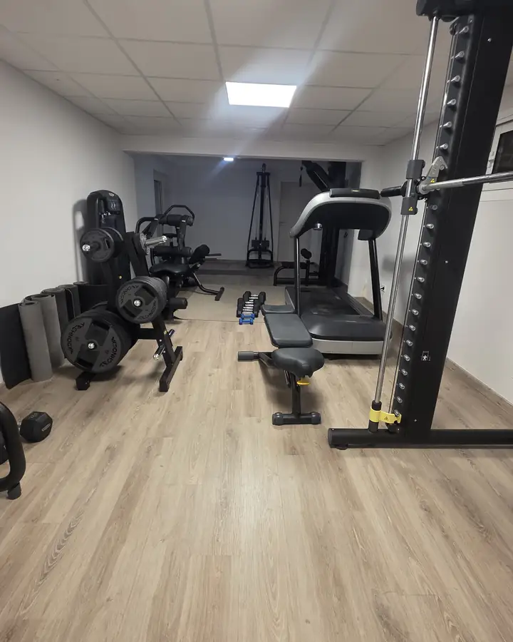 The villa's private gym with a treadmill, cable rig and weights.