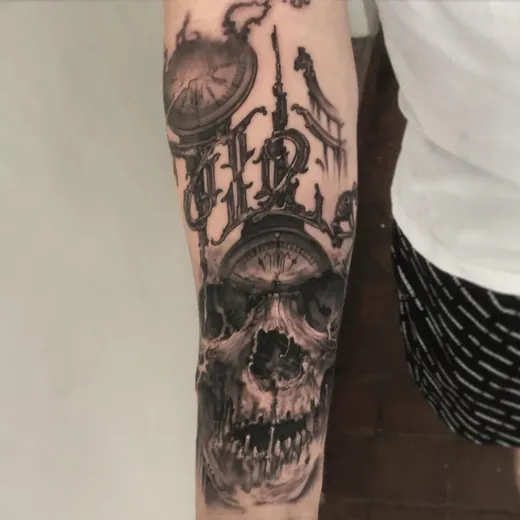 Skull with candle in black and grey on a forearm