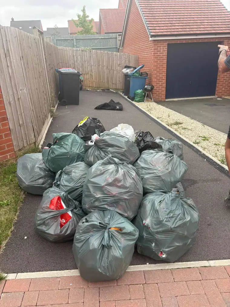 Bagged household waste stacked tidily ready for collection