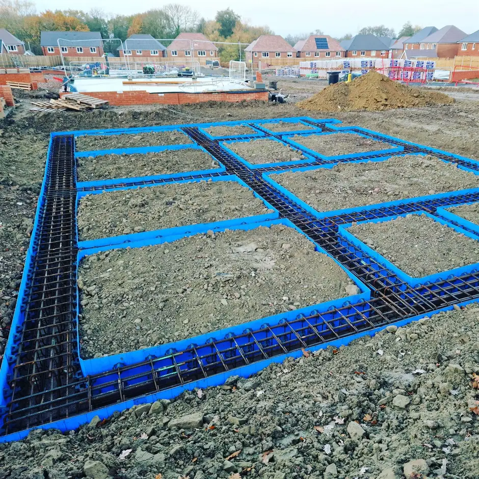 Reinforced raft foundation with steel rebar and blue formwork