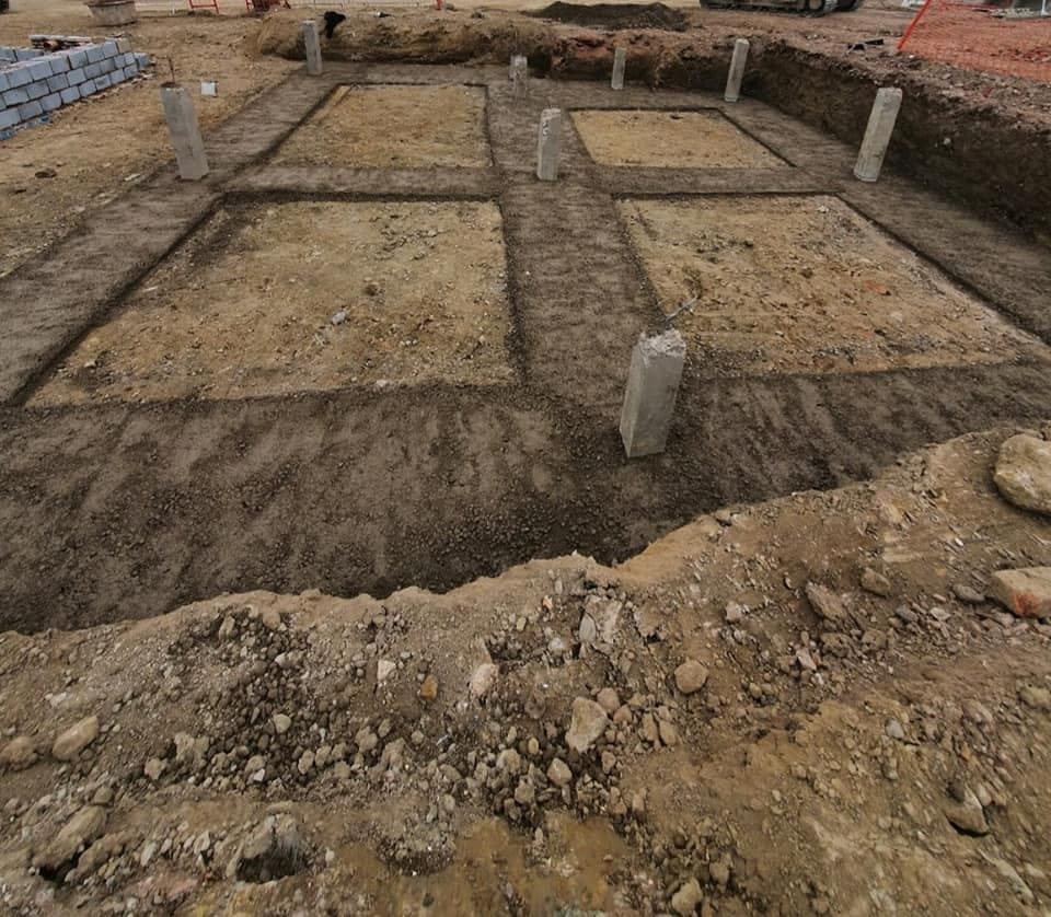 Excavated foundations with concrete pad-stones and columns