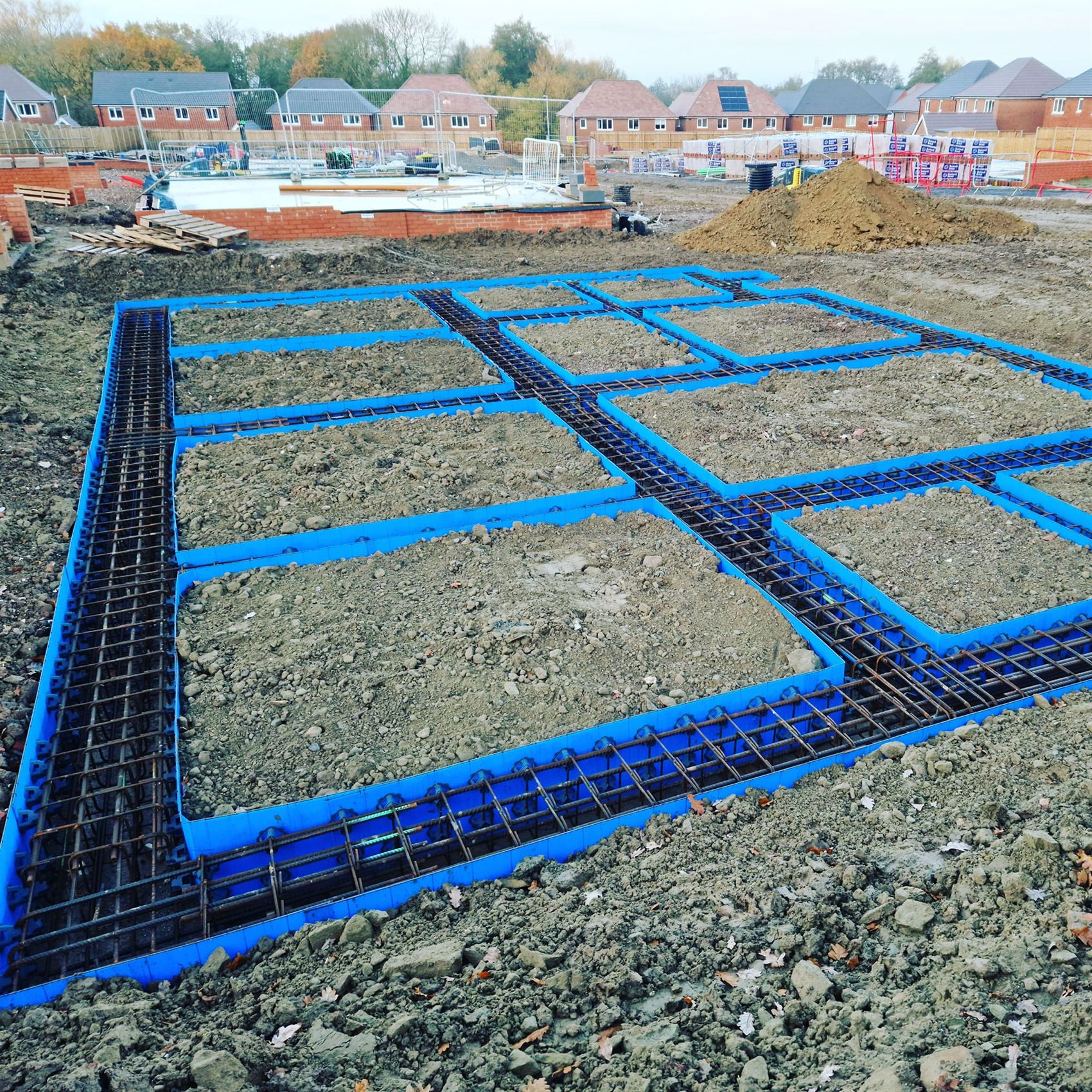 Reinforced raft foundation with steel rebar and blue formwork