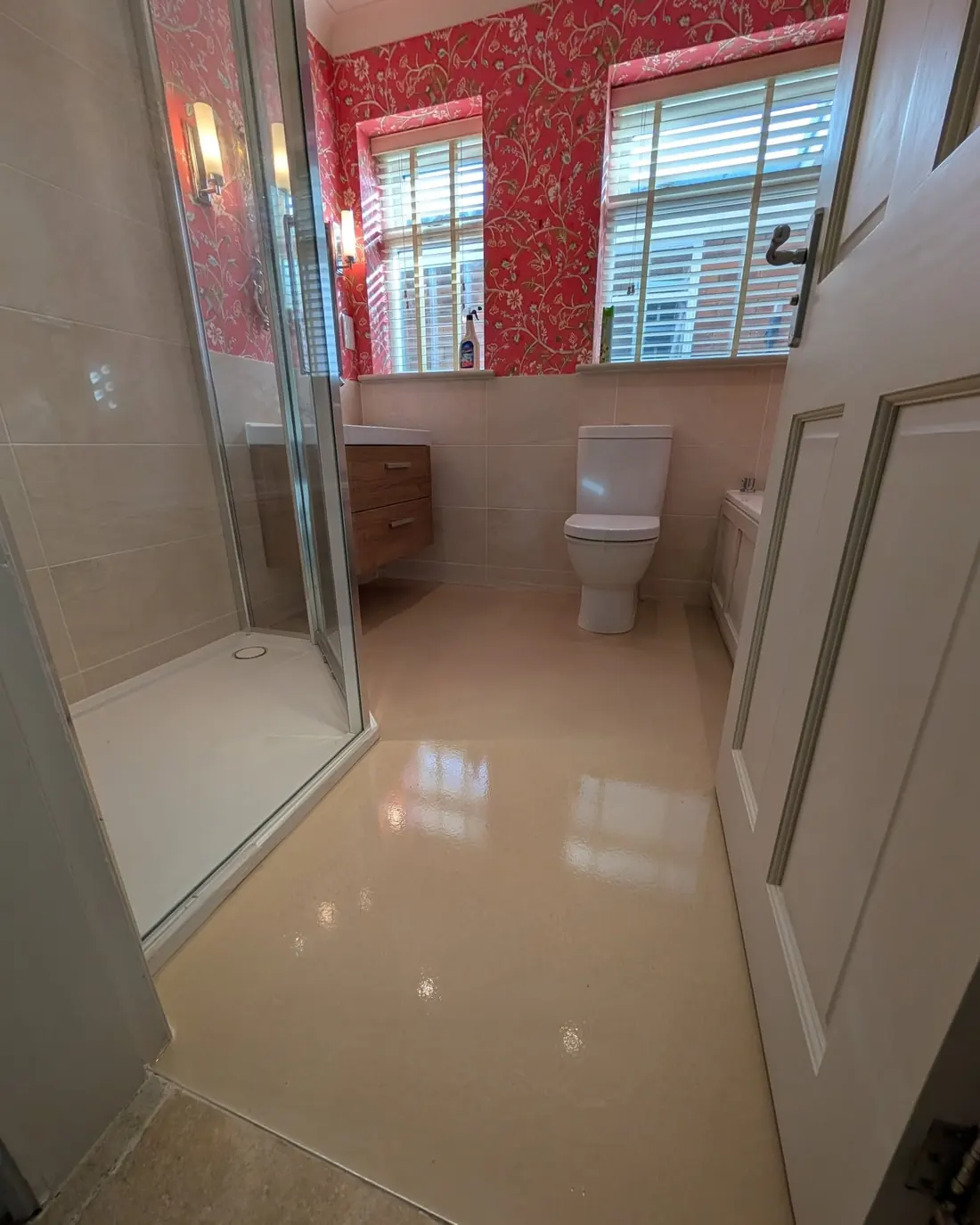 The same bathroom with glossy cream latex screed poured across the whole floor.