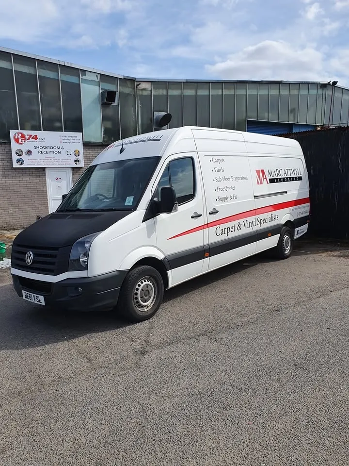 Marc Attwell Flooring's white Volkswagen Crafter van, signwritten with Carpets, Vinyls, Sub Floor Preparation, Free Quotes and Supply and Fit down the side.