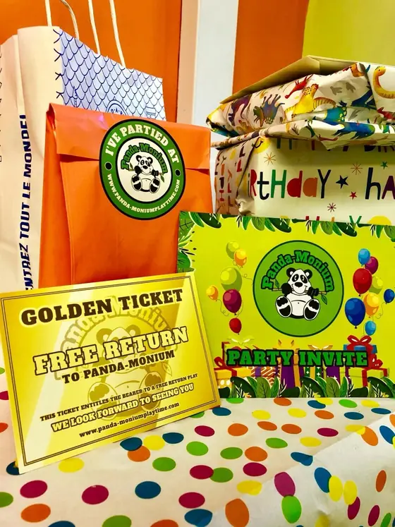 A party bag, a Party Invite card, and the gold and green Golden Ticket voucher for a free return visit to Panda-Monium.