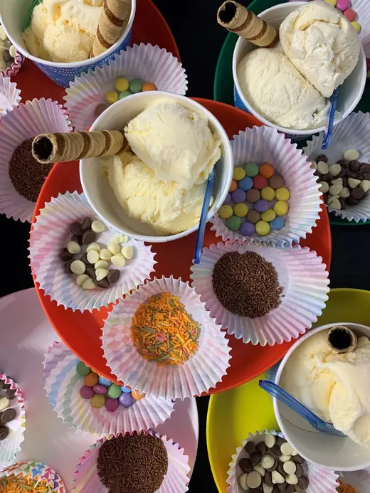 The ice cream station: tubs of ice cream ringed by cupcake cases of sprinkles, chocolate balls and wafer rolls.