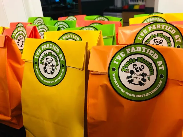 Orange and yellow party bags printed I Partied At Panda-Monium Playtime, with the green panda roundel.