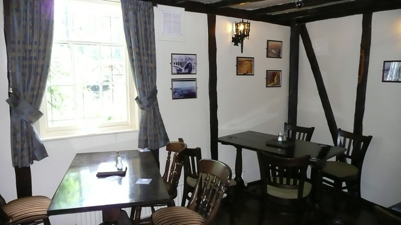 The beamed dining room hung with old photographs of the Iron Bridge