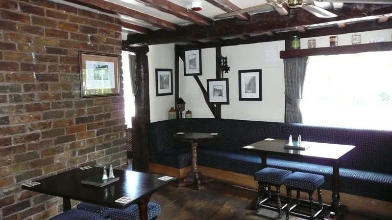 The brick-and-beam snug with its banquette seating