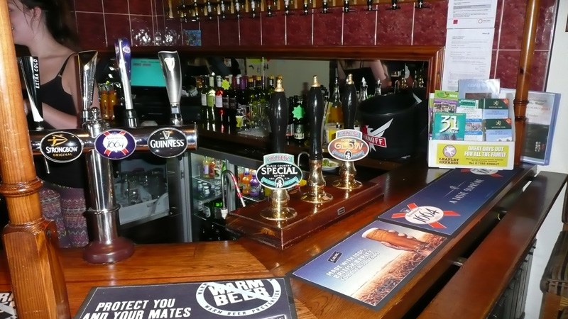 Holden's hand pumps and the brass bar at Ye Olde Robin Hood Inn