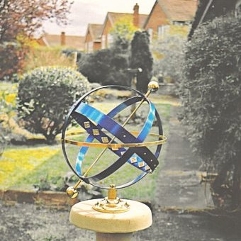 The Azure armillary in sky-blue anodized aluminium and brass, fitted with brass ball tips at the poles.