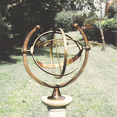 The Capricornus armillary in bronze with matching brass, its sphere pivoted between two Capricornian horns.