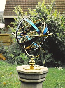 The rich blue Celeste armillary as a feature in a garden setting.
