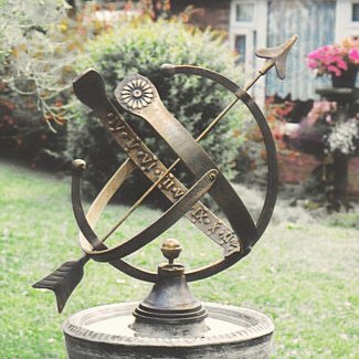 The all-bronze Draco armillary, its open Equatorial design showing the raised Roman numerals.