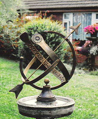 The all-bronze Draco armillary, its open Equatorial design showing the raised Roman numerals.