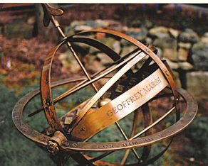 A close view of a Taurus armillary with a personal inscription engraved along the equatorial band.